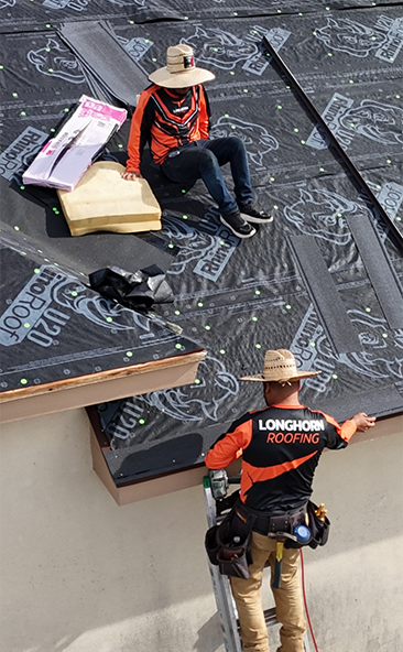 Roofer installing underlayment